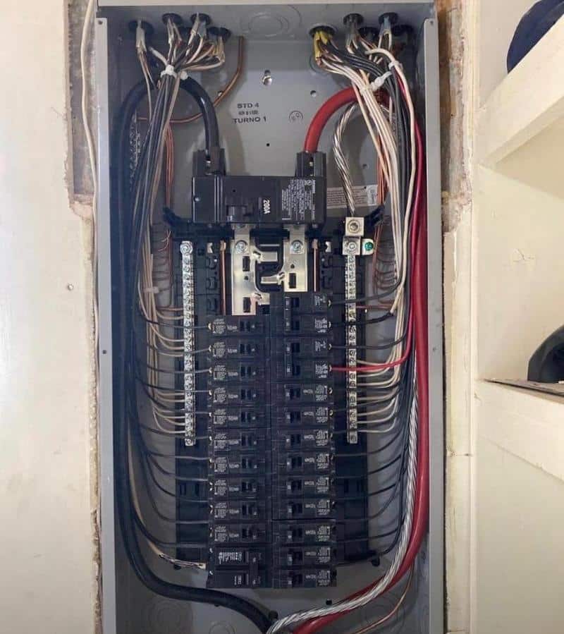 Electrical panel with circuit breakers and wiring, representing electrical services for residential and commercial needs in Kansas City.