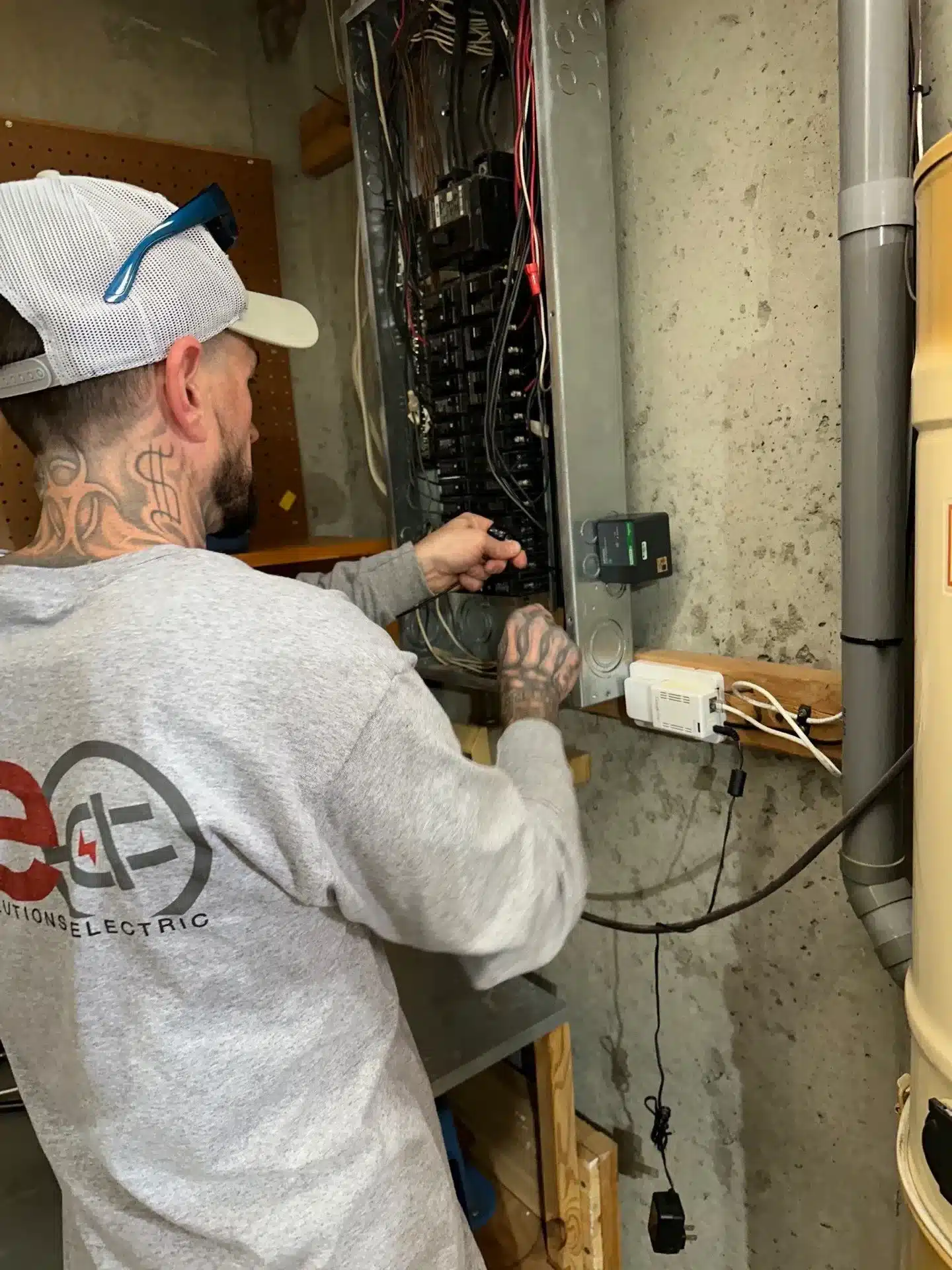 Electrician working on a residential electrical panel, showcasing professional electrical installation services by Current Solutions Electric in Kansas City.